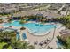 Aerial view of a sparkling community pool surrounded by lush landscaping, seating areas, and resort-style amenities at 17996 Adrift Rd, Winter Garden, FL 34787