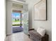 Stylish foyer featuring wood-look tile flooring, a cozy bench, and a view of the outdoors at 17996 Adrift Rd, Winter Garden, FL 34787