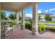 Cozy front porch with brick flooring and decorative stone pillars at 17996 Adrift Rd, Winter Garden, FL 34787