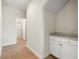 Bright hallway with wood-look tile floors and a bathroom with a glass-enclosed shower in the background at 17996 Adrift Rd, Winter Garden, FL 34787
