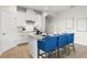 Stylish kitchen with white cabinetry, stainless steel appliances and a central island with seating at 17996 Adrift Rd, Winter Garden, FL 34787