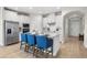 Beautiful kitchen features a central island, white cabinets, stainless steel appliances and seating for three at 17996 Adrift Rd, Winter Garden, FL 34787