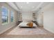 Spacious main bedroom with tray ceiling, carpeted floors, two windows, and a walk-in closet at 17996 Adrift Rd, Winter Garden, FL 34787