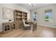 Elegant home office featuring a built-in bookcase and natural light at 17996 Adrift Rd, Winter Garden, FL 34787