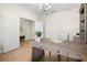 Well-lit office with desk, decorative plant and an open doorway leading to another room at 17996 Adrift Rd, Winter Garden, FL 34787