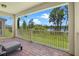 Covered patio with red brick flooring and stunning water view at 17996 Adrift Rd, Winter Garden, FL 34787