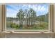 Picture window with scenic lake view and landscaping outside at 17996 Adrift Rd, Winter Garden, FL 34787
