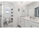 Bathroom featuring double sinks, a large mirror, and a separate toilet area with a shower-tub combo for added privacy at 2345 Volunteer Ave, Kissimmee, FL 34744