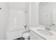 Bright, all-white bathroom featuring a tiled shower-tub combo, sleek toilet, and a modern vanity with a white countertop and sink at 2345 Volunteer Ave, Kissimmee, FL 34744