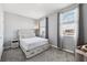 Light filled bedroom with two large windows, neutral walls, plush carpet and a bed with built in drawers at 2345 Volunteer Ave, Kissimmee, FL 34744