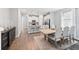 Open concept kitchen and dining area with modern lighting, stainless steel appliances, and hardwood floors at 2345 Volunteer Ave, Kissimmee, FL 34744