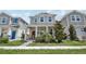 Charming two-story home with a welcoming front porch, beautiful landscaping, and a vibrant red front door at 2345 Volunteer Ave, Kissimmee, FL 34744