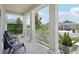 Inviting front porch features white columns and railing, seating, and pleasant neighborhood views at 2345 Volunteer Ave, Kissimmee, FL 34744