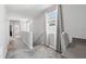 Bright upstairs hallway with carpet, featuring a window with gray curtains and a built-in desk with gray countertop at 2345 Volunteer Ave, Kissimmee, FL 34744