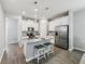 Modern kitchen with stainless steel appliances, an island with seating, and plenty of cabinet space at 2345 Volunteer Ave, Kissimmee, FL 34744