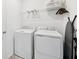 Efficient laundry room with white washer and dryer, wire shelving and room for all your laundry essentials at 2345 Volunteer Ave, Kissimmee, FL 34744
