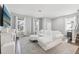 Cozy living area with white sofa, modern fireplace, and views of the outdoor landscape through the windows at 2345 Volunteer Ave, Kissimmee, FL 34744