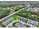 This high-angle shot features townhomes near a community, abundant green spaces, and a major road at 2508 Seven Oaks Dr, St Cloud, FL 34772
