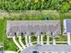 An aerial perspective captures a townhome community featuring manicured landscaping and uniform architectural design at 2508 Seven Oaks Dr, St Cloud, FL 34772