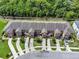 Overhead view of a well-maintained townhome community with mature trees and manicured lawns for a serene setting at 2508 Seven Oaks Dr, St Cloud, FL 34772