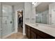 This bathroom features a glass-enclosed shower and dark wood cabinets, offering a luxurious retreat at 2508 Seven Oaks Dr, St Cloud, FL 34772