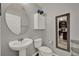 This powder room offers a stylish pedestal sink and a decorative mirror, conveniently located near the kitchen at 2508 Seven Oaks Dr, St Cloud, FL 34772