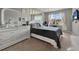 The spacious bedroom features a large dresser, ceiling fan and ample natural light at 2508 Seven Oaks Dr, St Cloud, FL 34772