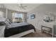 Bright bedroom with a ceiling fan, white curtains, and a vanity for getting ready in style at 2508 Seven Oaks Dr, St Cloud, FL 34772