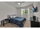 This cozy bedroom features a ceiling fan and a large window providing ample natural light at 2508 Seven Oaks Dr, St Cloud, FL 34772