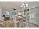 Cozy dining area with a chandelier, tile floors, sliding glass doors to the lanai, and seating for four at 2508 Seven Oaks Dr, St Cloud, FL 34772