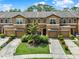 Inviting townhome boasts a symmetrical facade, lush landscaping, and private driveways, enhancing curb appeal at 2508 Seven Oaks Dr, St Cloud, FL 34772