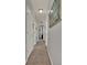 Hallway with carpet, neutral paint and doors leading to multiple rooms at 2508 Seven Oaks Dr, St Cloud, FL 34772