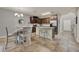 Charming kitchen featuring an island with barstool seating, brown cabinets, and stainless steel appliances at 2508 Seven Oaks Dr, St Cloud, FL 34772