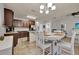 Beautiful kitchen with dark wood cabinets, tile backsplash, and white breakfast table with seating for four at 2508 Seven Oaks Dr, St Cloud, FL 34772
