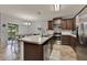 Beautiful kitchen with a kitchen island, modern appliances, dark cabinets, and a lovely dining area at 2508 Seven Oaks Dr, St Cloud, FL 34772