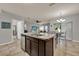 Spacious kitchen with an island that offers barstool seating and views to a Gathering room and dining area at 2508 Seven Oaks Dr, St Cloud, FL 34772