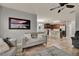 Open-concept living room flowing into a modern kitchen with a breakfast bar and dining area at 2508 Seven Oaks Dr, St Cloud, FL 34772