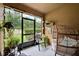 Cozy sunroom with textured walls and bright string lights with large sliding glass doors to let the sunshine in at 2508 Seven Oaks Dr, St Cloud, FL 34772