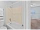 Bright bathroom showcasing a shower-tub combo and an adjacent window at 2517 Caper Ln # 207, Maitland, FL 32751