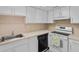Functional kitchen features white cabinets, laminate countertops, and essential appliances at 2517 Caper Ln # 207, Maitland, FL 32751