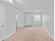 A neutral living room with a door to the hallway and a window to the outside at 2517 Caper Ln # 207, Maitland, FL 32751