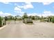 Cadence Park community entrance with stone pillars, black iron gate, landscaping, and well-maintained surroundings at 2541 Leyland Cypress Ln, Sanford, FL 32773