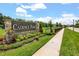 Cadence Park community sign with stone pillars, colorful landscaping, manicured lawn, and sidewalks at 2541 Leyland Cypress Ln, Sanford, FL 32773