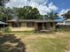 Cozy single-story house featuring yellow siding, traditional windows, and a compact front porch at 2601 Tennessee Rd, Lakeland, FL 33815