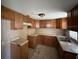 Functional kitchen featuring wood cabinetry, a double basin sink, and a compact layout with ample storage at 2601 Tennessee Rd, Lakeland, FL 33815