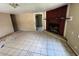 Vacant living room with tile floors and a fireplace provides a blank canvas for a new owner's vision at 2601 Tennessee Rd, Lakeland, FL 33815