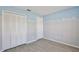 Bedroom featuring wood-look floors, a closet, light-blue accents, and a window with blinds at 2742 Woodruff Dr, Orlando, FL 32837