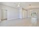 Spacious living room featuring neutral paint, tile flooring, ceiling fan, and sliding glass doors at 2742 Woodruff Dr, Orlando, FL 32837