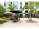 Outdoor amenity space featuring a tiki bar, seating, and lush landscaping for social gatherings at 300 E South St # 6016, Orlando, FL 32801