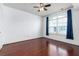 Bedroom with hardwood floors, ceiling fan, and large window with lots of natural light at 300 E South St # 6016, Orlando, FL 32801